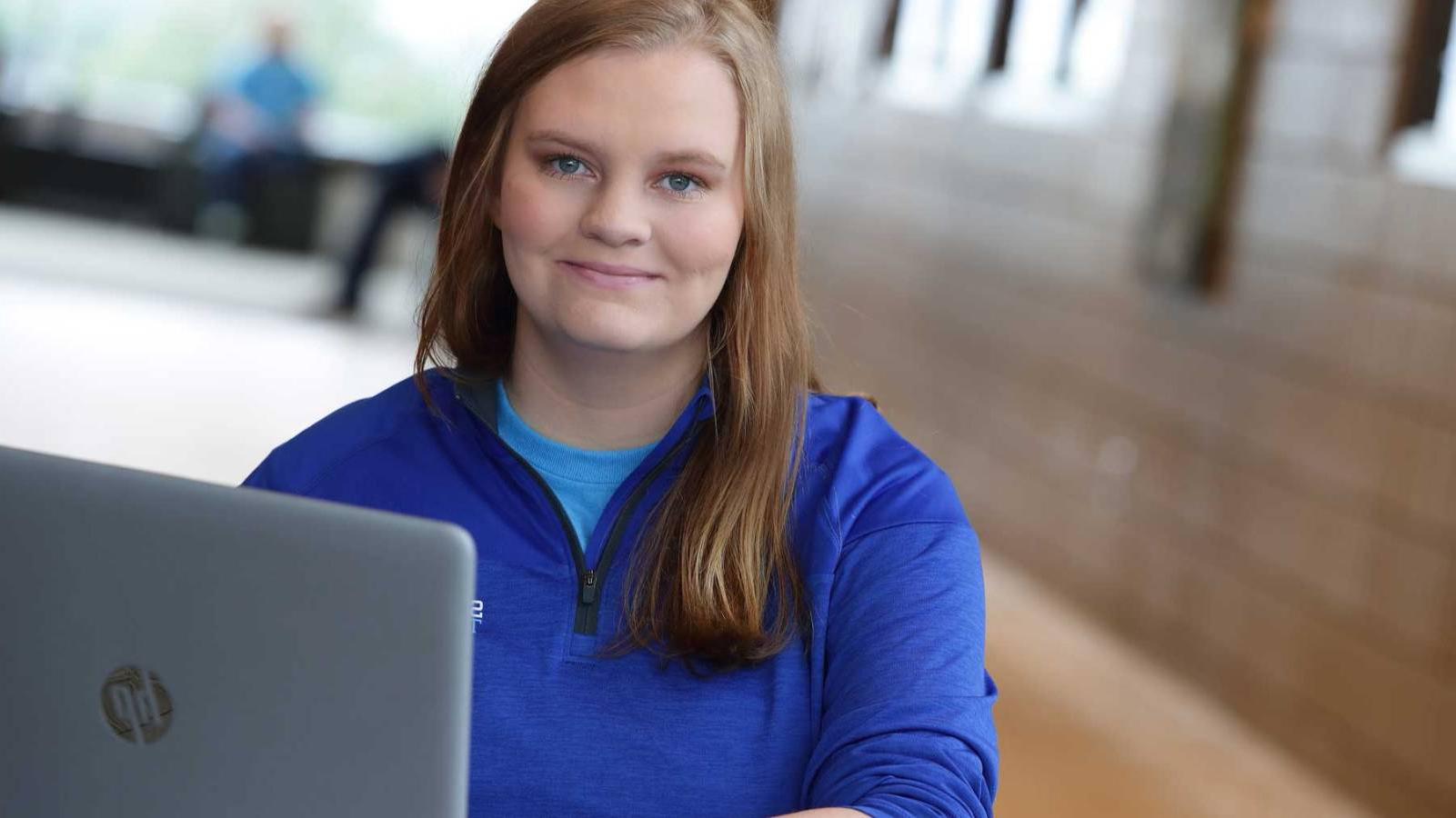 young female student with laptop